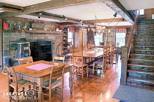Interior of Adirondack Inn dining room showing hand hewn beams